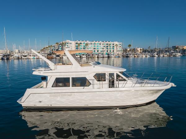 Navigator Pilothouse 2007 Navigator Pilothouse yacht docked in a marina with clear blue skies.