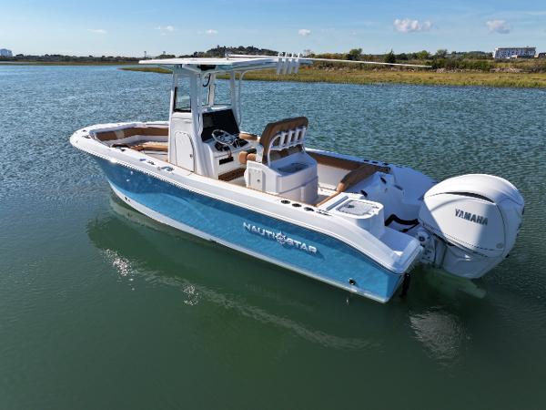 NauticStar 242OS 2025 NauticStar 242OS boat on calm water with Yamaha engine.