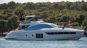 Azimut S7 Luxury 2018 Azimut S7 yacht cruising on a serene waterway with lush greenery backdrop.