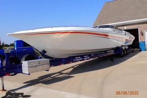 Fountain 47 Lightning 2006 Fountain 47 Lightning boat on trailer, parked in driveway near garage.