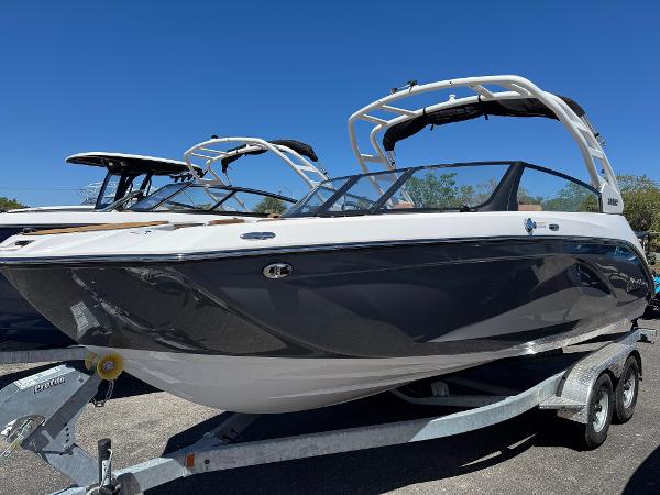 Yamaha Boats 222SD 2025 Yamaha Boats 222SD on trailer, sleek design, black and white exterior, sunny day.