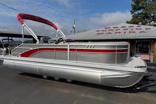 Bennington 22 ssxb 2025 Bennington 22 SSXB pontoon boat with red canopy, parked outdoors.