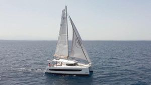 Bali CATSMART 2024 Bali CATSMART catamaran sailing on open sea under clear skies.