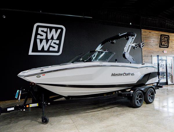 MasterCraft NXT20 2024 MasterCraft NXT20 boat on display in showroom with SWWS branding.