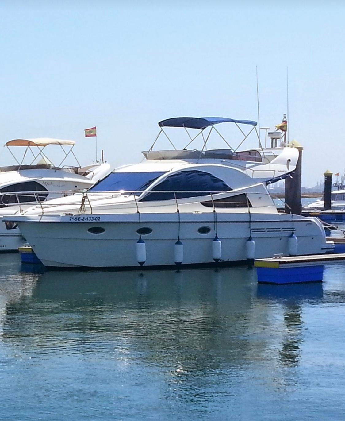 Rodman 38 2002 Rodman 38 yacht docked in a marina, surrounded by calm water.