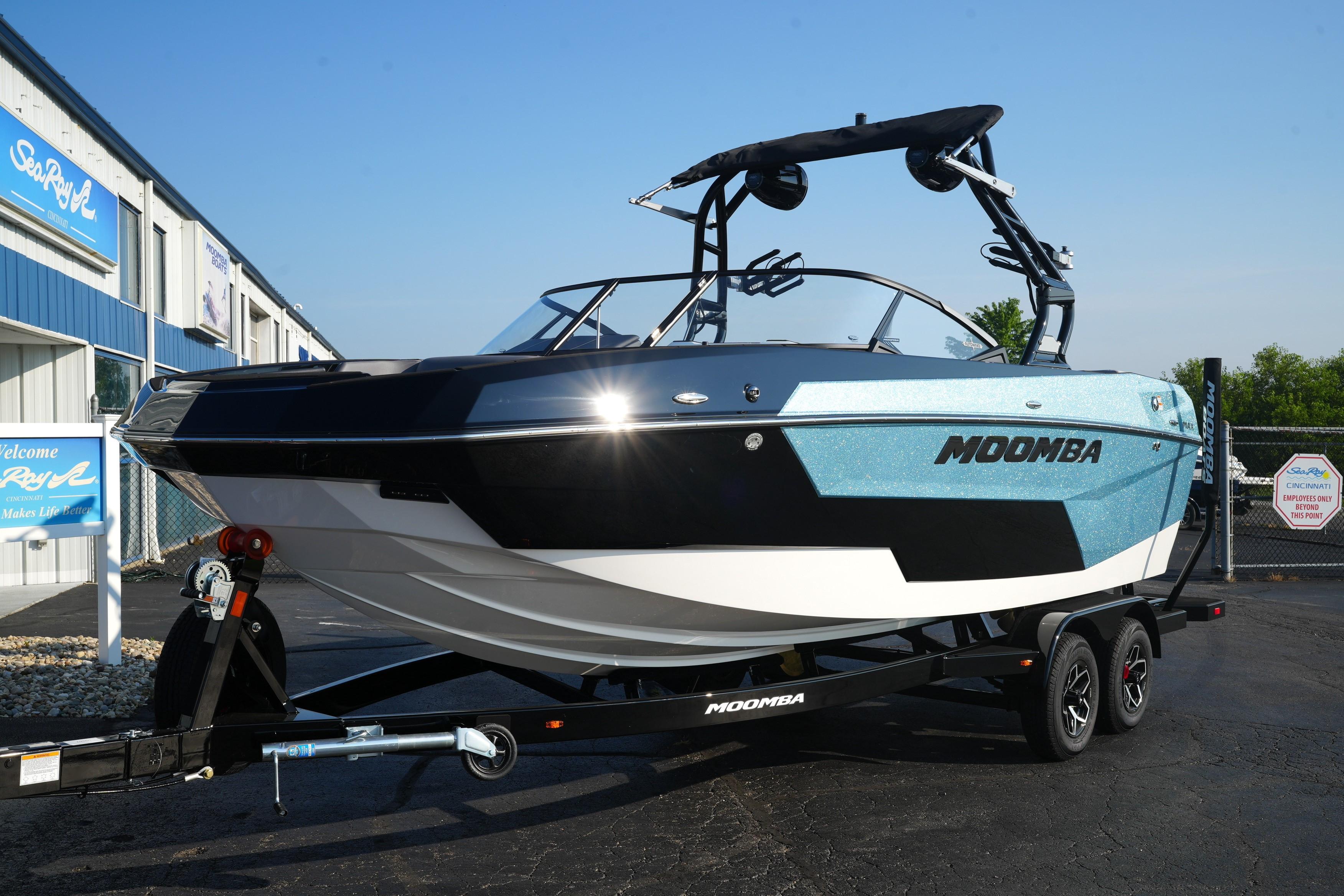 Moomba Max 2025 Moomba Max boat on trailer, parked outside dealership.