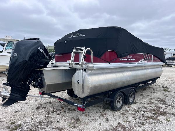 Sun Tracker Party Barge 22 RF XP3 2022 Sun Tracker Party Barge 22 RF XP3 pontoon boat on trailer, covered and parked outdoors.