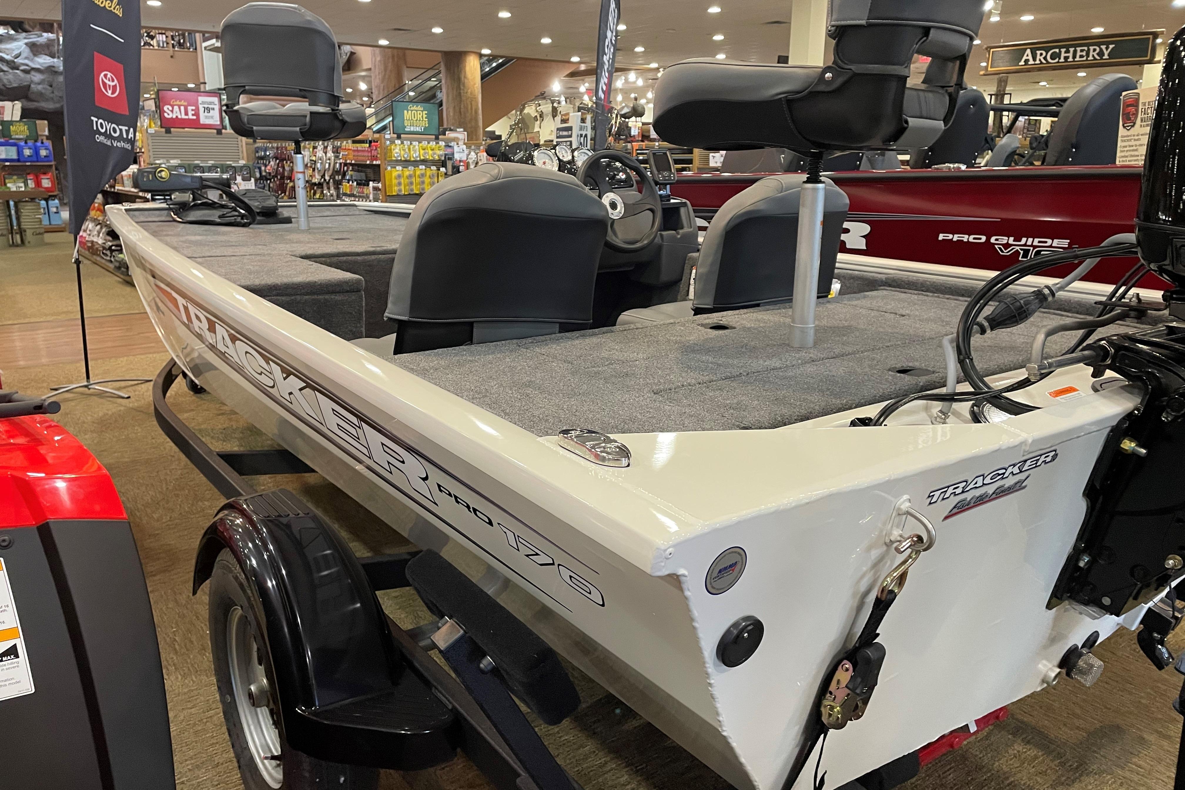Tracker Pro 170 2026 Tracker Pro 170 boat displayed indoors, featuring seating and steering console.