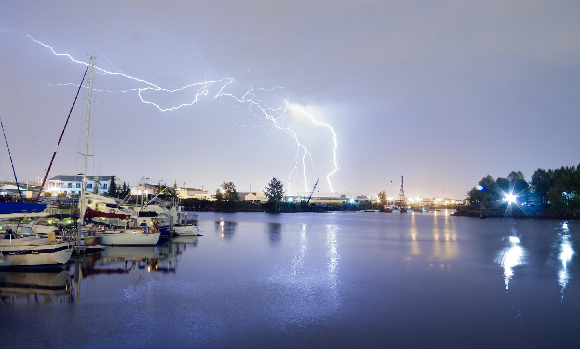 Lightning Bolts Over Boats In The water