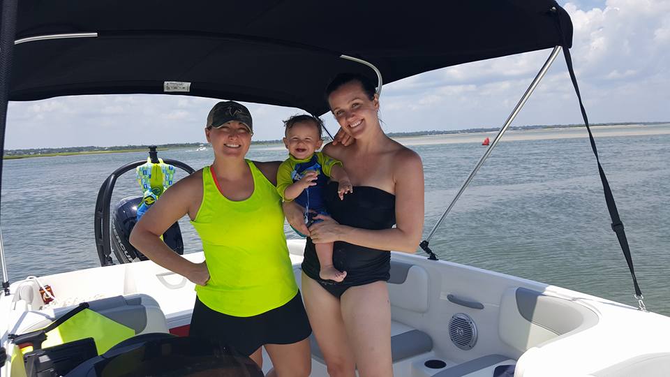 Brent, along with his two moms, Tiffany and Whitney, cool off in the shade of their boat's bimini top.